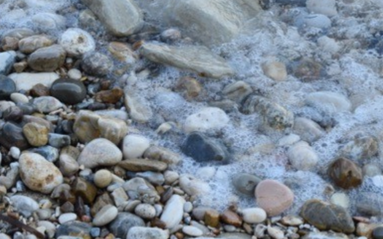 Water over pebbles on a beach